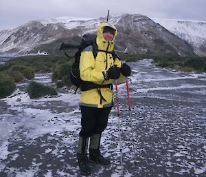 Dave clad in full field gear with walking poles on a snowy day ready for work