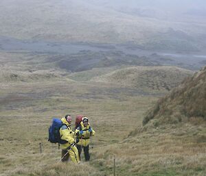 Matt and Mel pause on the track heading down into Bauer Bay, where the hut can be seen in the distance