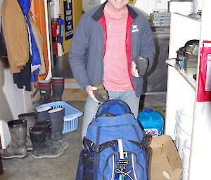 Expeditioner pulls large rocks out of his backpack