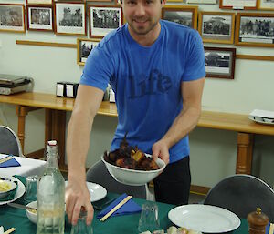 expeditioner placing numerous dishes on the table