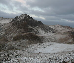 A landscape photo of snow ranges with a person hidden amongst everything