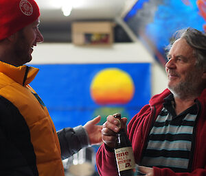 Expeditioner awarding colleague with a beer as first prize
