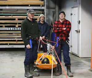 Dave, Garry and Jack pose with a sled during search and rescue training