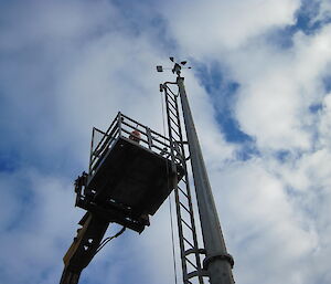 Gunny, Bureau of Meteorology, in a crane repairing something