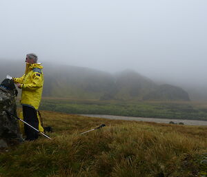 Dave S poses in full gear with misty landscape around him