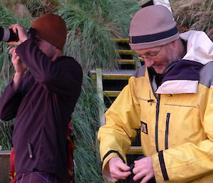 Stephen with camera and Dave working on something, standing side by side