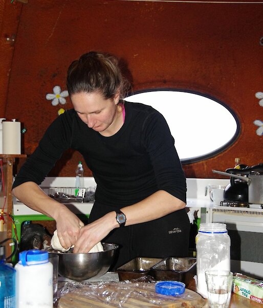 Lauren making bread at Waterfall Bay hut