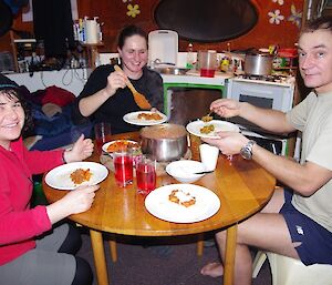 Maria, Lauren and Mango enjoying dinner at Waterfall Bay hut