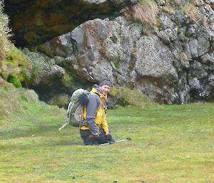 An expeditioner sinks into wet ground on Macca, both legs in