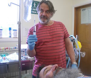 Expeditioner poses with syringe during medical training