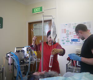 Dr Mel training Andrew on how to set up fluids