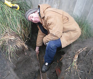 Tom repairing the damaged pipe