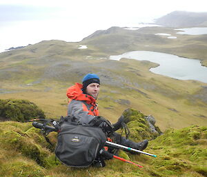 Cam poses for the camera with a beautiful view behind him