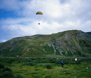 Supplies flown in and dropped by parachute — the way things were done in 1984