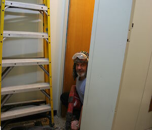 Jim removing tiles from one of the old bathrooms