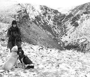 Jane, Supervisor, Dog Handler, with dogs in the snow