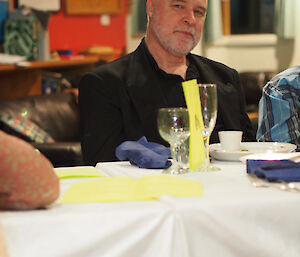 Gunny poses at dinner in a nice black shirt and black blazer