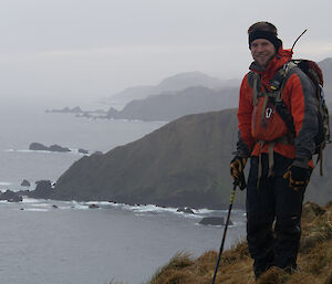 Cameron poses at top of a cliff