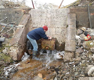 Robby trying to stop a dam leak