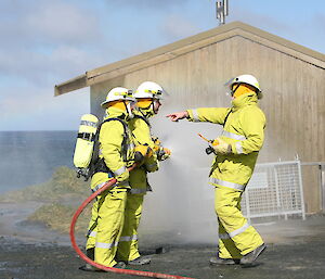 Gunny providing direction on how to use fire hose during firefighting training