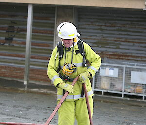 Colin feeding the hose through during firefighting training