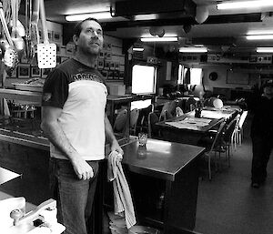 Tom acting as slushy for the day, a black and white photo in the kitchen