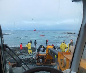 Birds eye view from inside a vehicle looking out at the beach, water and L'Astrolabe