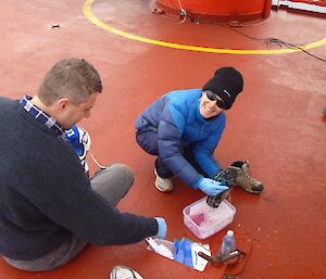 Anna and Charles cleaning their gear before arriving Macquarie Island