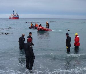 Shore team ready to assist cargo unloading on beach