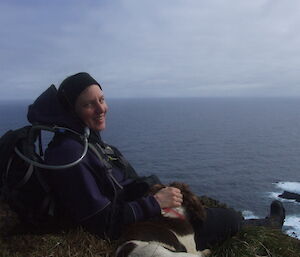 Dana with Joker, the dog, with sea in background