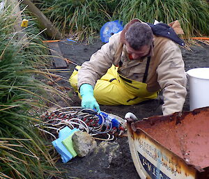 Charles cleaning air manifold in fuel farm