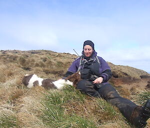 Dana with Joker the dog, having a rest on a hill