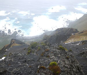 View from the top of a steep hill down to Hurd Point hut