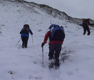 Anna, Jaimie and Richard hiking up a snowy hill