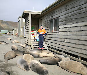Greg outside his office surrounded by weaning seal pups