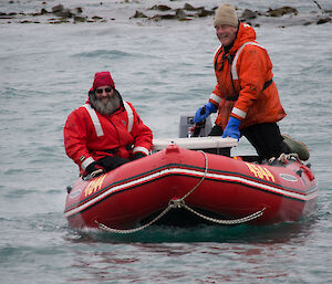 Ray and Greg in a red, inflatable boat