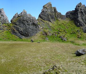 Mawson Point showing a green clearing surrounded by high, pointy rocks