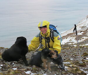 Kelly with dogs Wags and Tamar, water in background