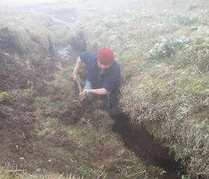 Robby removing the blockage to the water supply