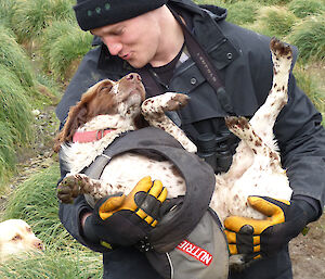 Jack holding Katie (dog) and pretending to give her a kiss