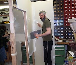 Pete listening to Chippy Jim’s instructions while plastering a wall