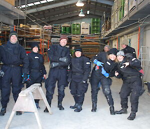 A group of expeditioners in dry suits ready to go out into the water