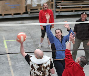 Expeditioners play volleyball inside the storage facility
