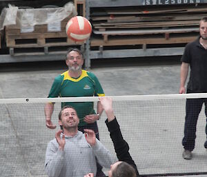 Boxing Day volleyball — shows ball in play just above the net with expeditoners either side ready for it