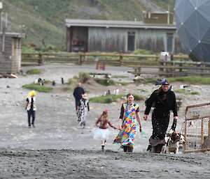 Dogs and their trainers parade in front of expeditioners before the annual dog race