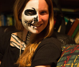 Karen who has one side of her face painted in black and white to look like a skeleton