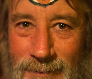 A close up of Gaz, who has a giant third eye painted on his forehead