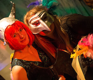 Lauren and Jaimie dressed in costume, viking on the left, pointy-nosed mask on the right