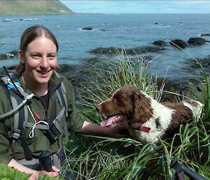 Female hunter with her dog in the tussocks