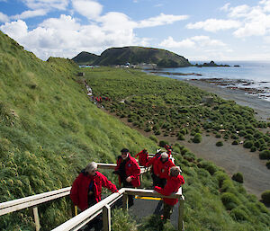 Tourists in red jackets walking up the stairs at one of the lookouts on station